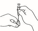 Hand holding a syringe with needle inserted into a transparent medicine vial