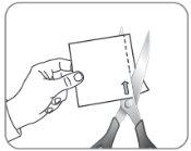 Hand holding a opened medication pouch with metal scissors showing the arrow indicating the cut