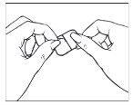 Hands holding a self-injection device with thumbs pressing the side buttons
