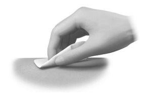 Hand applying a white medicated patch on light skin of the arm or torso