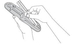 Hands holding the pre-filled syringe over the tray, preparing to remove it