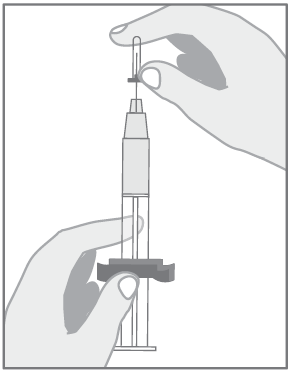 Hand holding the syringe with the needle, ready for injection