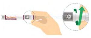 Vorivipeh injection device with a hand holding it and a close-up showing the dose adjustment at 27 units with green arrows