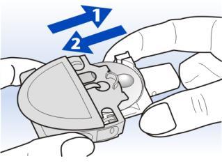 Dispositivo medico grigio tenuto da due dita con frecce blu numerate 1 e 2 che indicano i passaggi di utilizzo