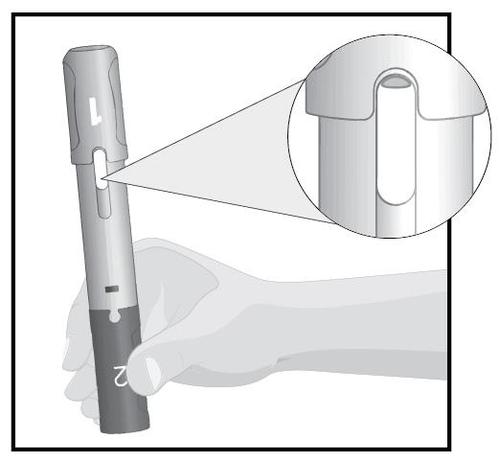 Penna per iniezione in mano con ingrandimento del meccanismo di rilascio della cartuccia e indicazione numerica sul corpo