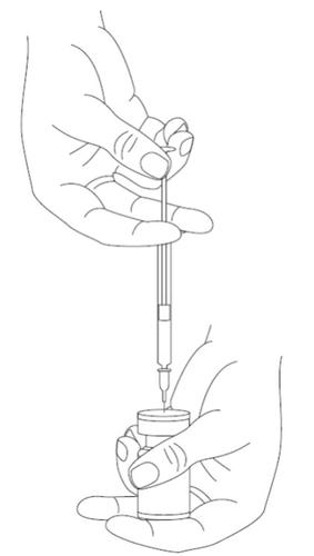 Mano che tiene una siringa pronta per l