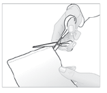 Mano che utilizza una pinza per afferrare e tirare un lembo di pelle durante una procedura chirurgica su un cuscinetto bianco