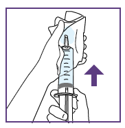 Mano che tiene una siringa pronta per l