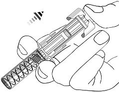 Dispositivo autoiniettante con molla a vista tenuto in mano, pronto per l