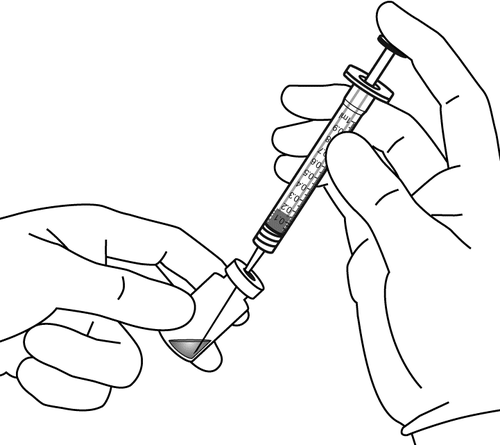 Mano che tiene una siringa graduata con ago, pronta per l