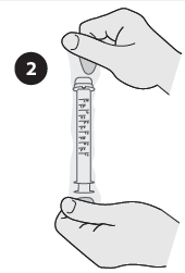 Mani che tengono una siringa graduata, con l