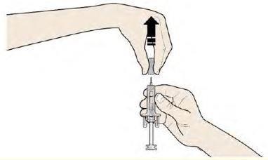 Mano che tiene una siringa preriempita con ago inserito nella cannula di un dispositivo medico sottocutaneo