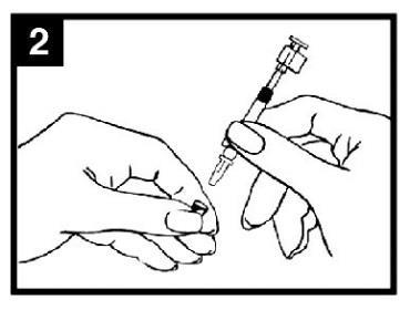 Mano che tiene una siringa pre-riempita con ago rivolto verso la pelle per l