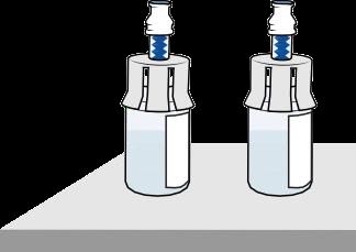 Due fiale medicinali trasparenti con tappi blu e corpo bianco su una superficie grigia chiara