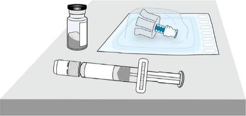 Fiala di farmaco, siringa pre-riempita e ago in confezione sterile su superficie grigia preparazione all