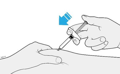 Mano che tiene una siringa pronta per l