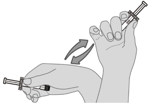 Mano che tiene una siringa pronta per l