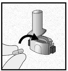 Capsula inserita in un dispositivo cilindrico con freccia che indica la direzione di rotazione