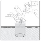 Fiala di vetro immersa in un bicchiere d