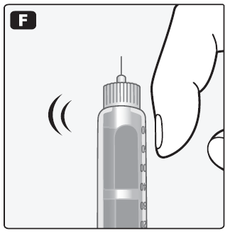 Siringa preriempita con ago esposto e mano che la tiene per l