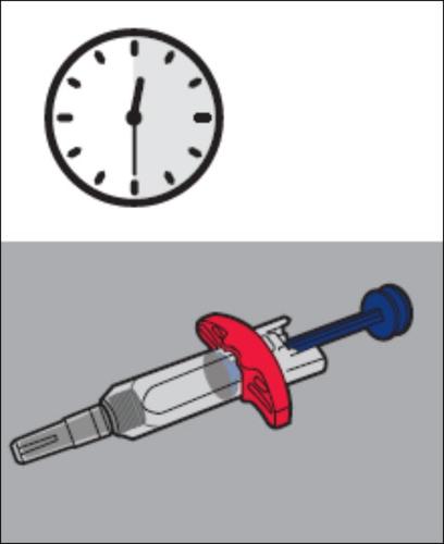 Siringa preriempita con dispositivo di sicurezza rosso e ago visibile accanto a un orologio che segna le 10:10