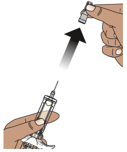 Mano che tiene una siringa piena mentre un