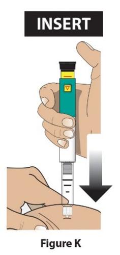 Mano che tiene un autoiniettore verde e bianco con una finestra di controllo gialla mentre preme verso il braccio con un ago inserito