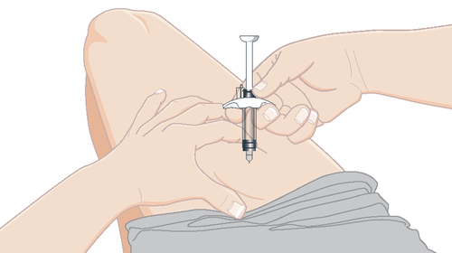 Mano che tiene una siringa pronta per l