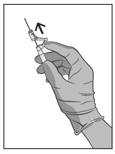 Mano con guanto che tiene una siringa preraempita con ago rivolto verso l