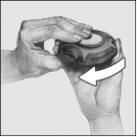 Hand holding a device auto-injector with a white arrow indicating the direction of application