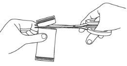 Scissors cutting an eye patch or rectangular white adhesive patch held with metal tweezers on a white background