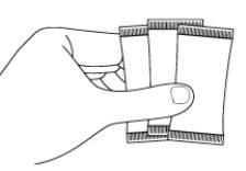 Hand holding a blister pack with four white rectangular tablets with scored edges