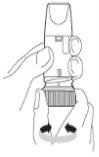 Hand holding an inhalation device with mouthpiece and cylindrical base showing arrows indicating the direction of use