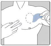 Hand applying pressure over the injection site on the upper arm with a light blue patch covering the area